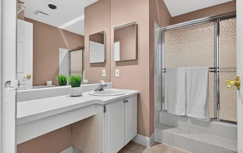 a view of bathroom with a sink and mirror