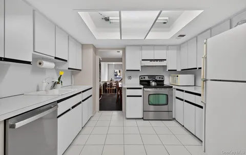 a kitchen with a stove sink and refrigerator