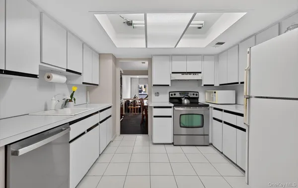 a kitchen with a stove sink and refrigerator