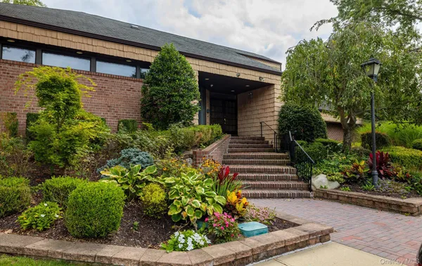 a view of a livingroom with hardwood floor and a large window