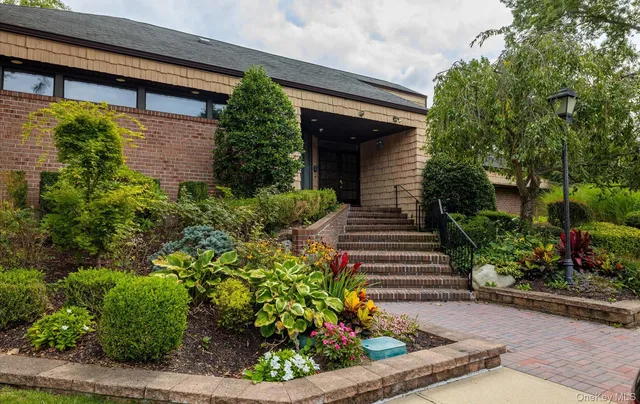 a view of a livingroom with hardwood floor and a large window