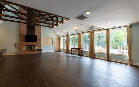 a living room with fireplace furniture and a flat screen tv