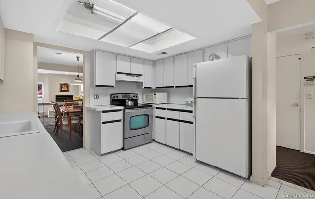 a kitchen with cabinets and white stainless steel appliances