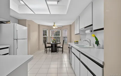 a kitchen with stainless steel appliances granite countertop a sink and a refrigerator