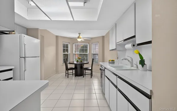 a kitchen with stainless steel appliances granite countertop a sink and a refrigerator