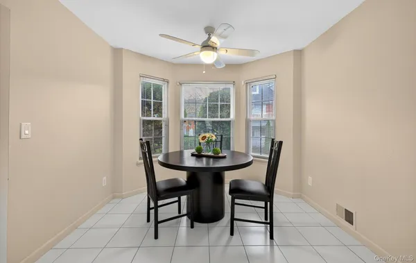a dining room with furniture and window