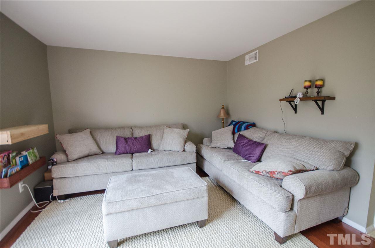 1245 Schaub Drive, Unit 1245 Raleigh, NC 27606 - Photo 2 of 10 a living room with furniture and a couch
