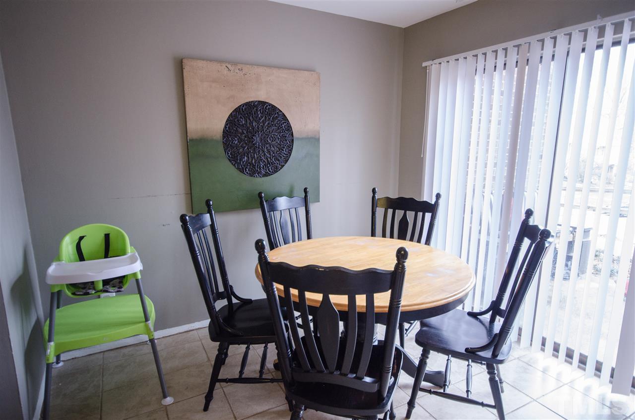 1245 Schaub Drive, Unit 1245 Raleigh, NC 27606 - Photo 5 of 10 a view of a dining room with furniture and a window