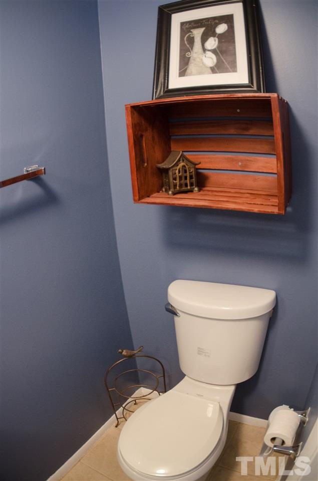 1245 Schaub Drive, Unit 1245 Raleigh, NC 27606 - Photo 6 of 10 a bathroom with a toilet a sink and mirror