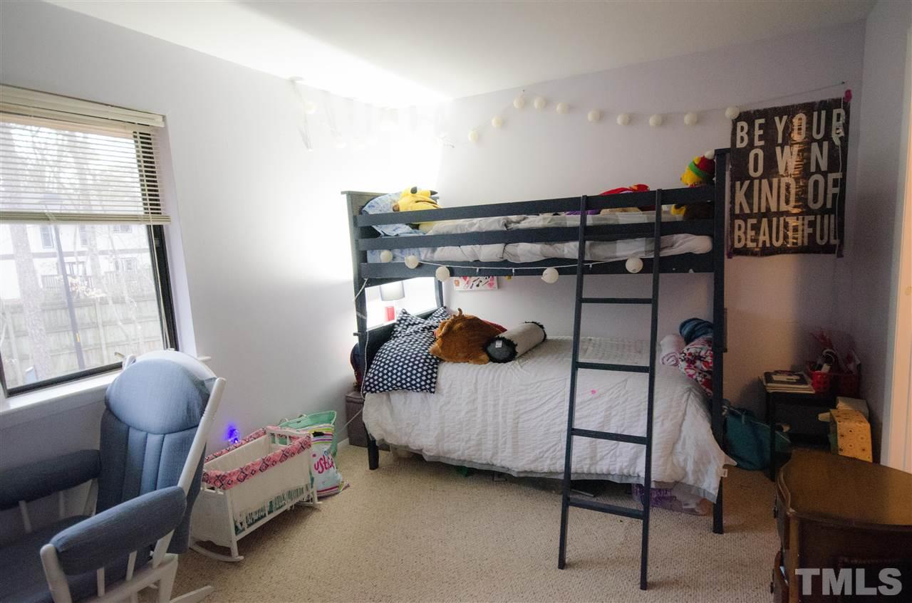 1245 Schaub Drive, Unit 1245 Raleigh, NC 27606 - Photo 7 of 10 a bedroom with a bed and a window