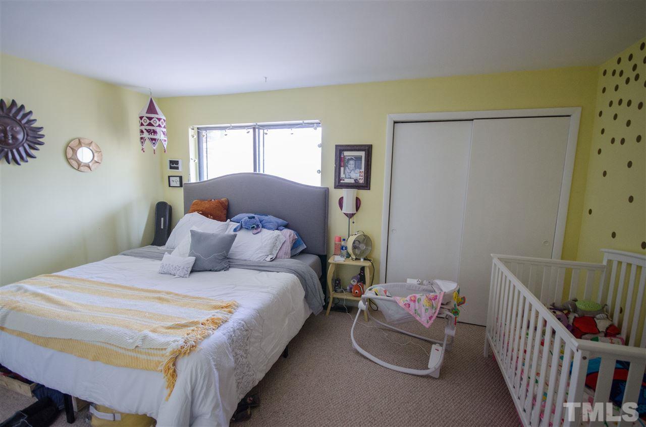 1245 Schaub Drive, Unit 1245 Raleigh, NC 27606 - Photo 8 of 10 a bedroom with a bed and a window