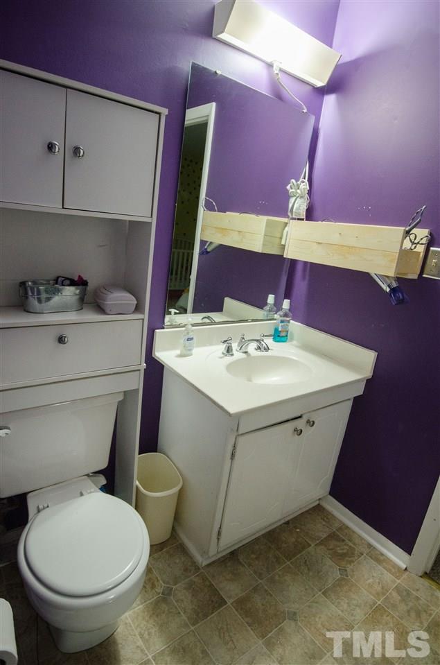 1245 Schaub Drive, Unit 1245 Raleigh, NC 27606 - Photo 9 of 10 a bathroom with a sink vanity and toilet