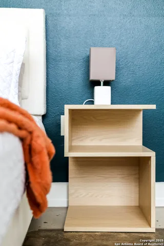 a bedroom with a bed and lamp