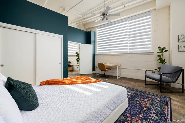 a bedroom with a bed and a night stand