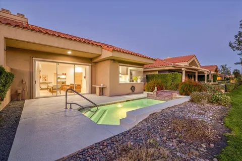 a view of a house with swimming pool and porch