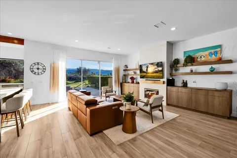 a living room with fireplace furniture and a flat screen tv