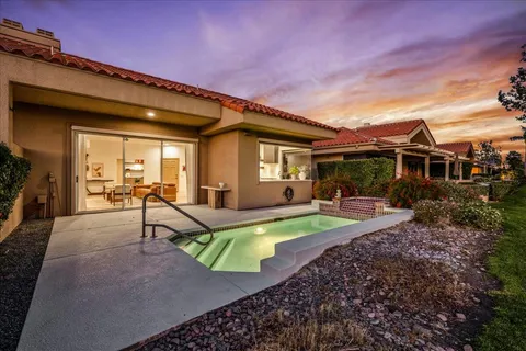 a view of a house with backyard porch and sitting area