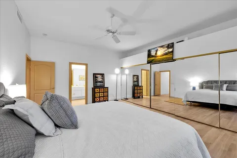 a bedroom with a large bed and a window