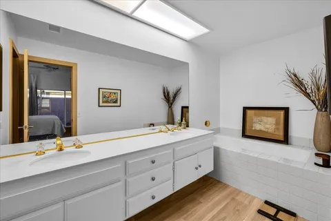 a bathroom with a sink a vanity and a mirror