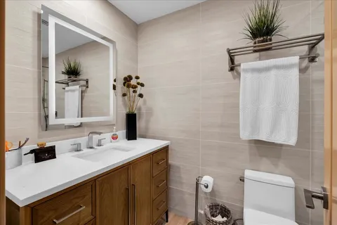 a view of a hallway with wooden floor and a living room