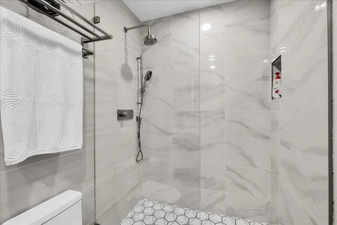 a view of an empty room with painting on the wall