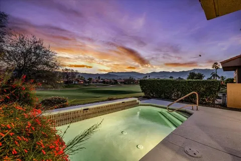 a view of a swimming pool and lounge chairs