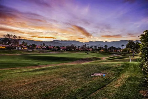a view of a lake with houses in the background