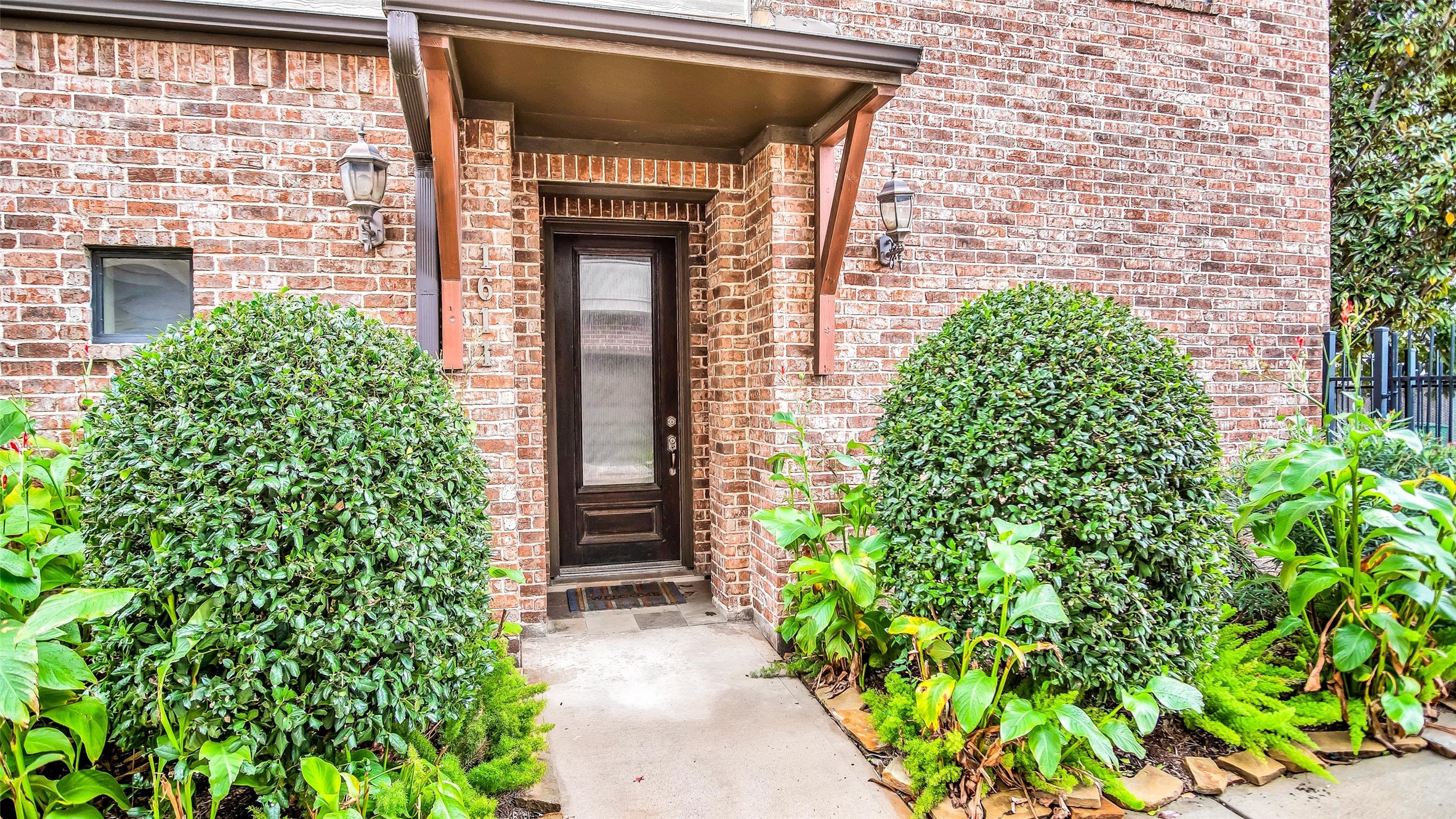 view of front door of house with green space