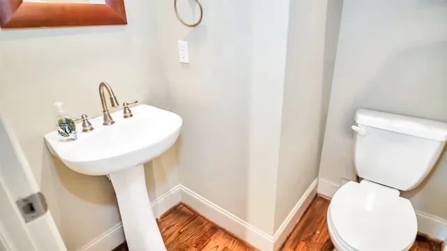 a bathroom with a toilet sink and mirror