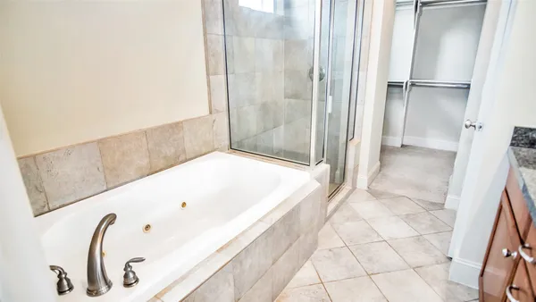 a bathroom with a bathtub and a shower