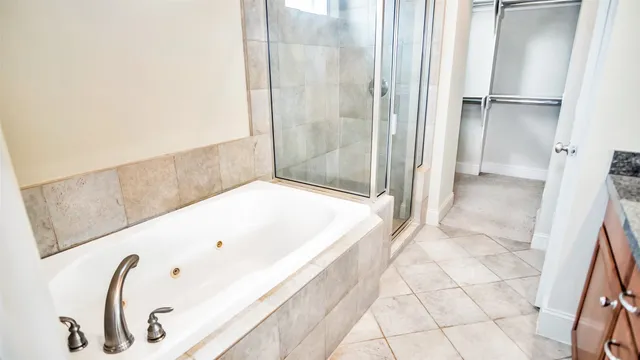 a bathroom with a bathtub and a shower