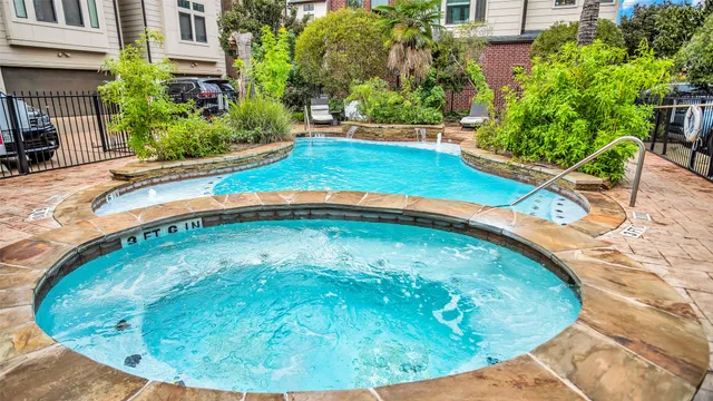 a view of a backyard with plants and patio