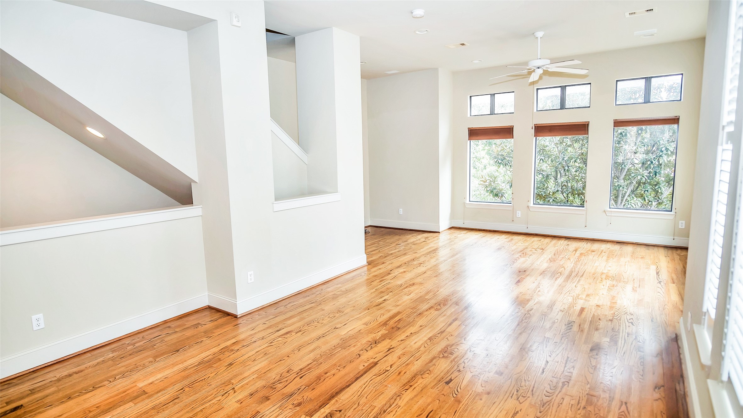 1611 Silver Street Houston, TX 77007 - Photo 6 of 32 a view of an empty room with wooden floor and a window