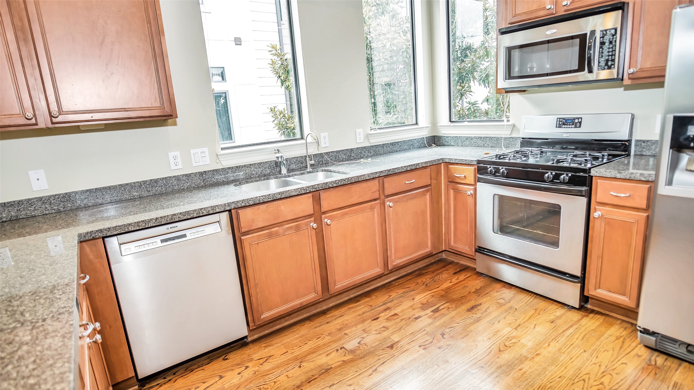 1611 Silver Street Houston, TX 77007 - Photo 9 of 32 a kitchen with granite countertop cabinets stainless steel appliances a sink and a window