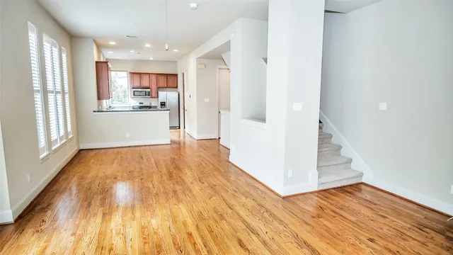 a view of a kitchen with wooden floor and a kitchen