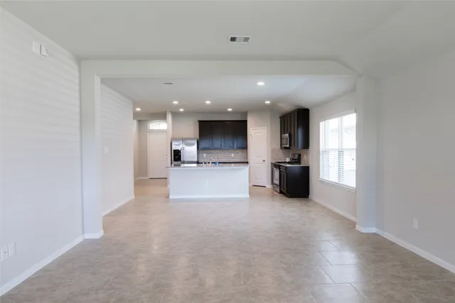 a view of a kitchen with a sink and a large window