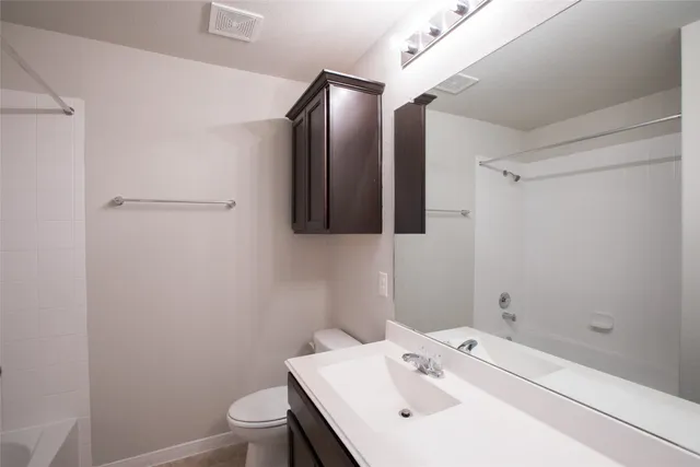 a bathroom with a sink toilet and vanity