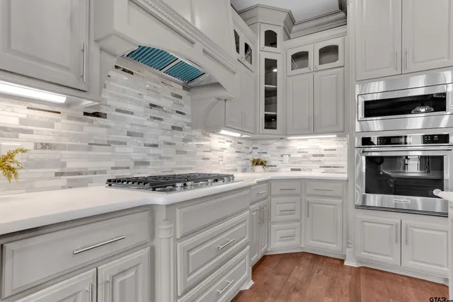 a kitchen with granite countertop white cabinets and white appliances