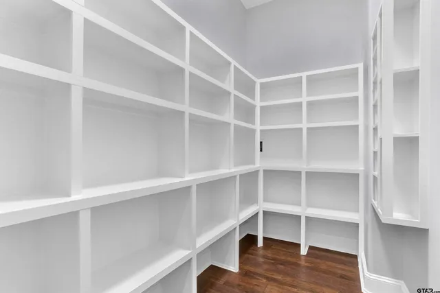 a view of walk in closet with empty racks
