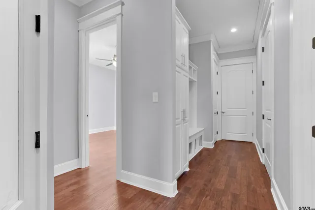 a view of a hallway with wooden floor