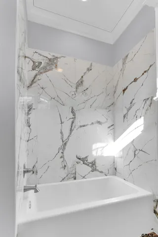 a bathroom with a bathtub and shower