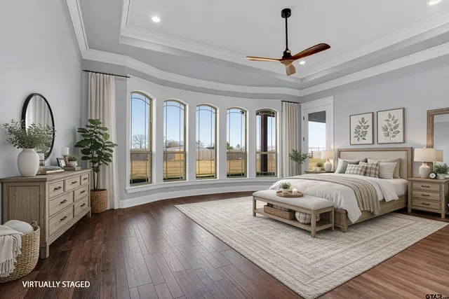 a spacious bedroom with bed and a large window