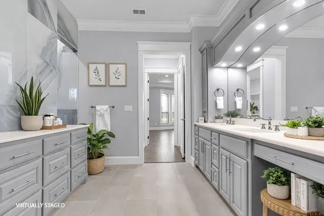 a bathroom with a granite countertop sink a toilet and with a large mirror