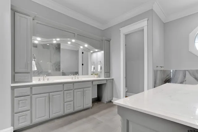 a large bathroom with a double vanity sink and a mirror