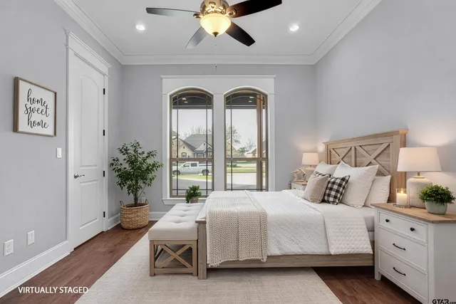 a bedroom with a bed and a potted plant