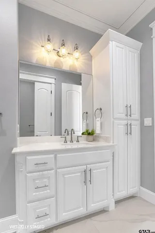 a bathroom with a double vanity sink and a mirror