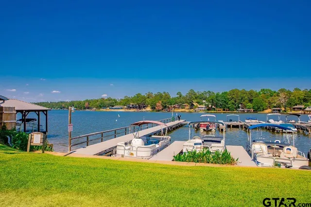a view of a swimming pool with a lawn chairs and a yard