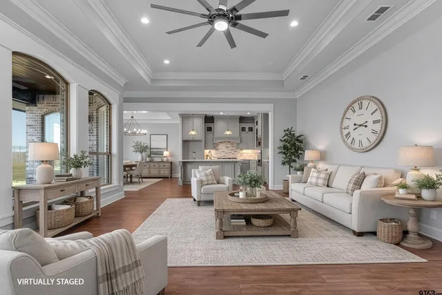 a living room with furniture a clock and a large window