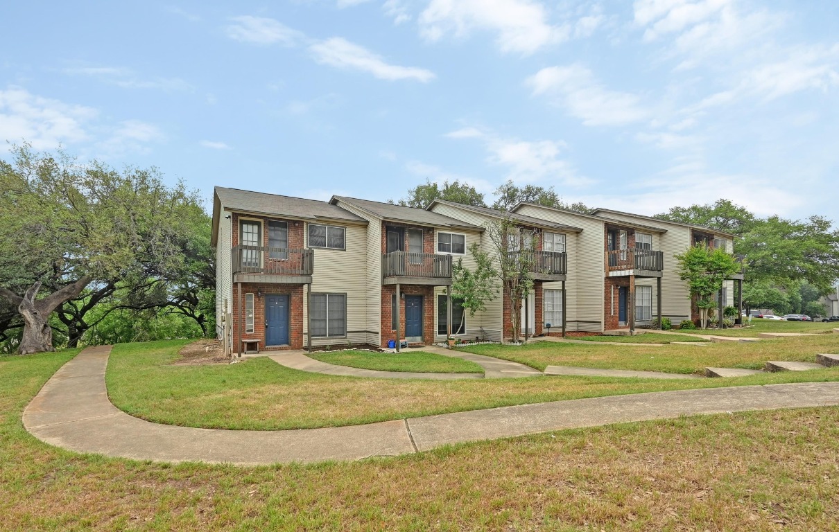 1815 River Crossing Circle, Unit A Austin, TX 78741 - Photo 1 of 1 a front view of building with yard and trees around
