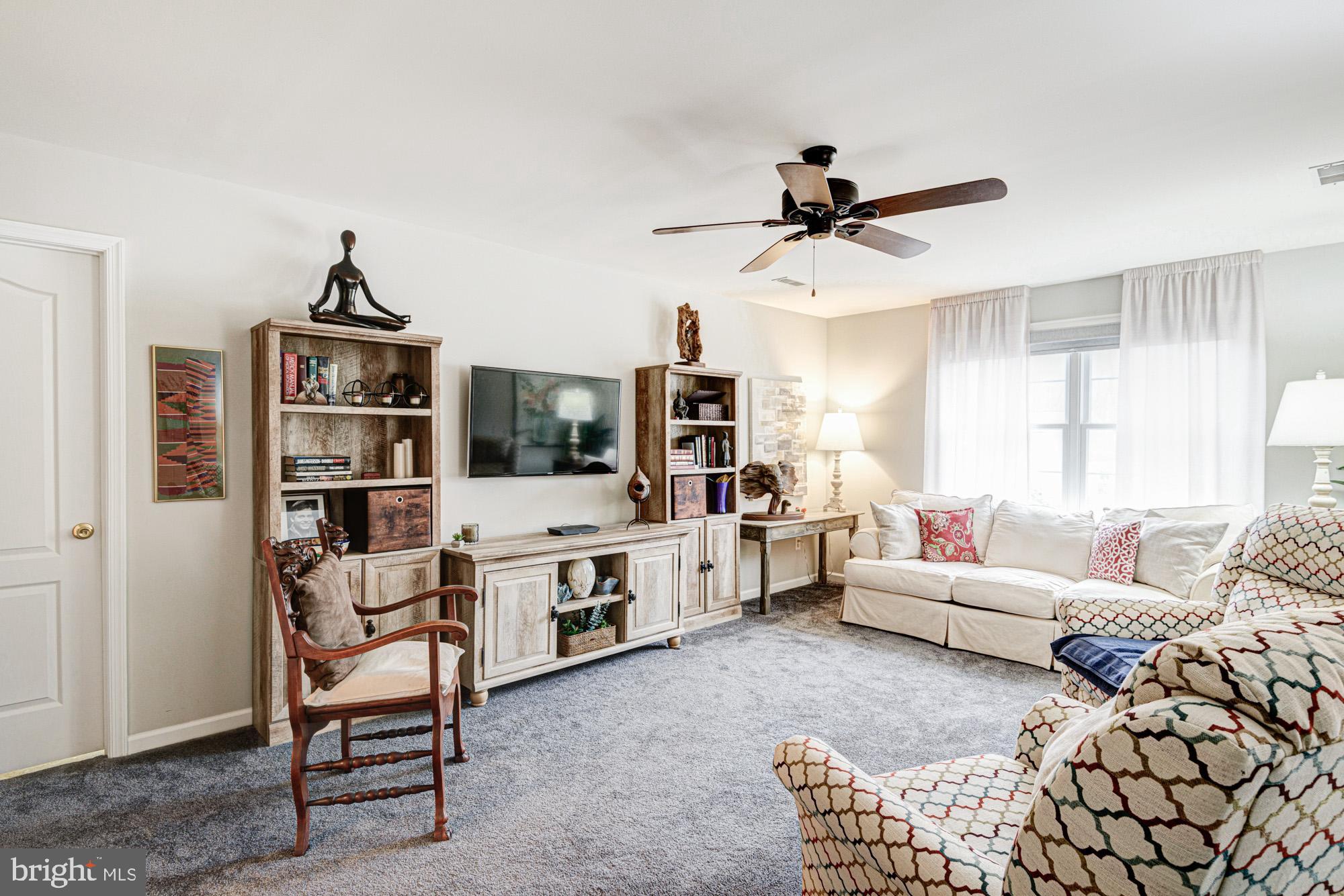 103 Candor Lane Dover, DE 19901 - Photo 20 of 38 a living room with furniture ceiling fan and a window